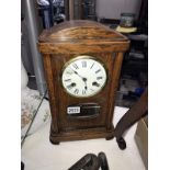 An oak case mantel clock with pendulum
