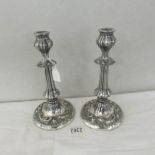 A pair of ornate silver plate candlesticks.