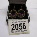 A pair of 1960's ear pendants set with amethysts in gold,.