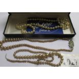 An imitation pearl necklace and 2 others (one a/f).