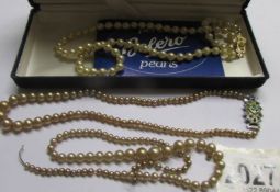 An imitation pearl necklace and 2 others (one a/f).
