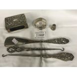 A silver match box holder, thimble, serviette ring, 2 silver handled button hooks and shoehorn.
