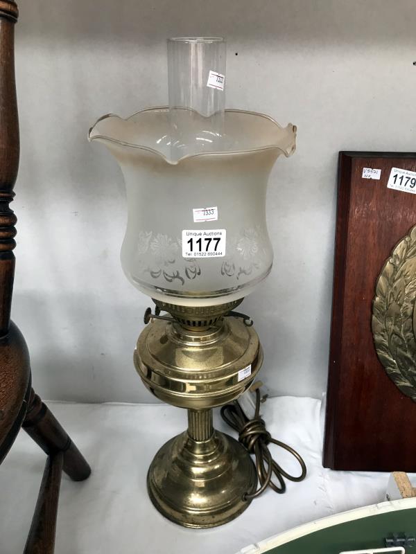 An electrical brass oil lamp with shade and chimney