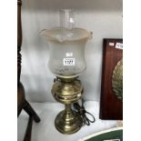 An electrical brass oil lamp with shade and chimney