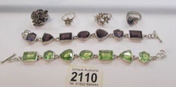 A purple stone bracelet, a green stone bracelet and 4 dress rings.