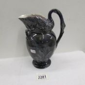 A Victorian jug with swan atop and swan neck and head as handle.
