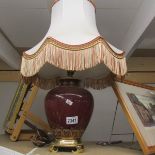 A pottery table lamp with shade.