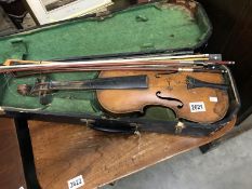 An old violin with 3 bows and wooden case.