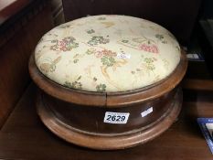 A mahogany footstool with tapestry top