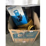 A submersible water pump and a roll of hose