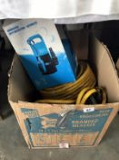 A submersible water pump and a roll of hose