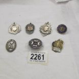 A mixed lot of silver badges and watch fobs.