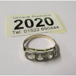 A 3 stone white sapphire 10ct gold ring.
