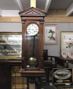 A mahogany case wall clock with 2 weights and pendulum