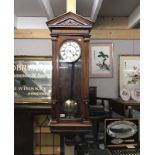 A mahogany case wall clock with 2 weights and pendulum