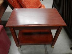 A darkwood stained tea trolley