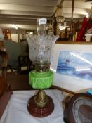 A Victorian oil lamp with moulded green glass font and original shade (shade a/f).