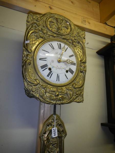 A French brass wall clock with pendulum. - Image 2 of 2