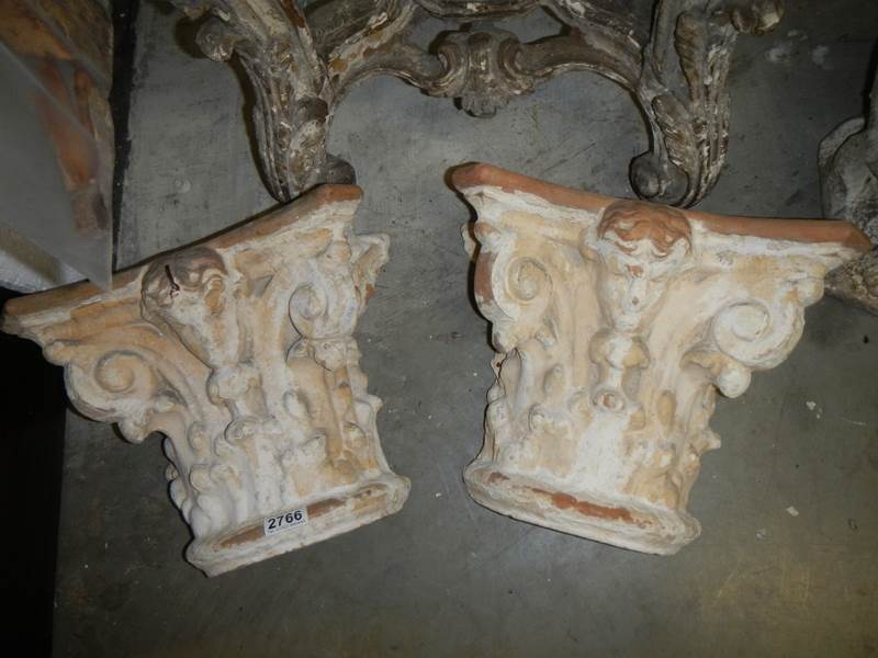 A pair of 19th century painted Terracotta Italina 'capitols'.