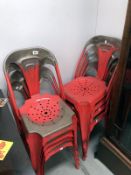 A set of 8 French attributed red metal stacking chairs