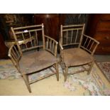 A pair of bamboo elbow chairs.