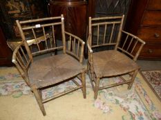 A pair of bamboo elbow chairs.