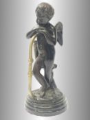 An antique bronze figure of Cupid/Eros.