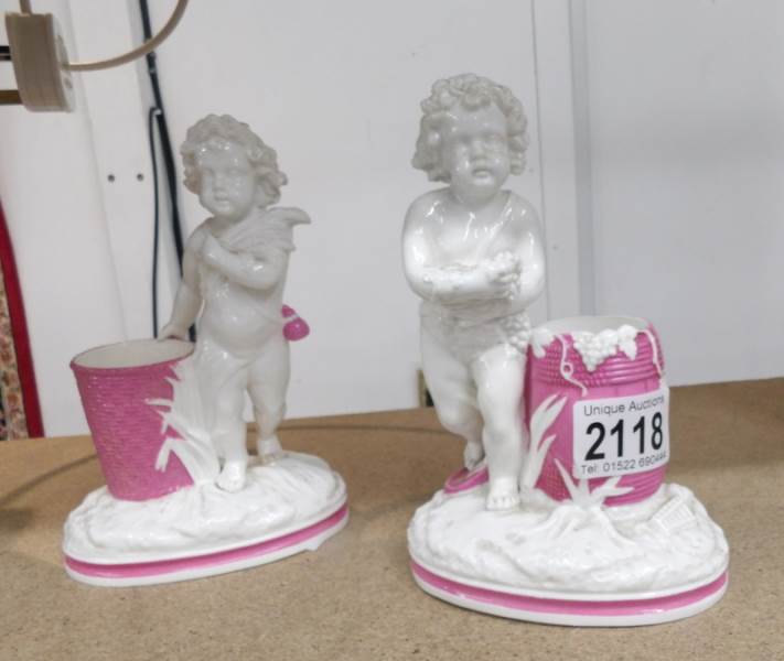 A pair of cherub figures gathering corn and grapes.