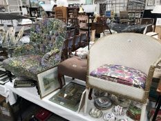 A nursing chair with a floral pattern and footstool (not matching pattern) and a Lloyd loom style