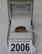 A 9ct gold ring set garnets, size K half.