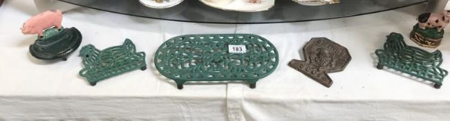 6 cast iron kitchen items including trivets,