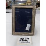 A small hall marked silver photograph frame.