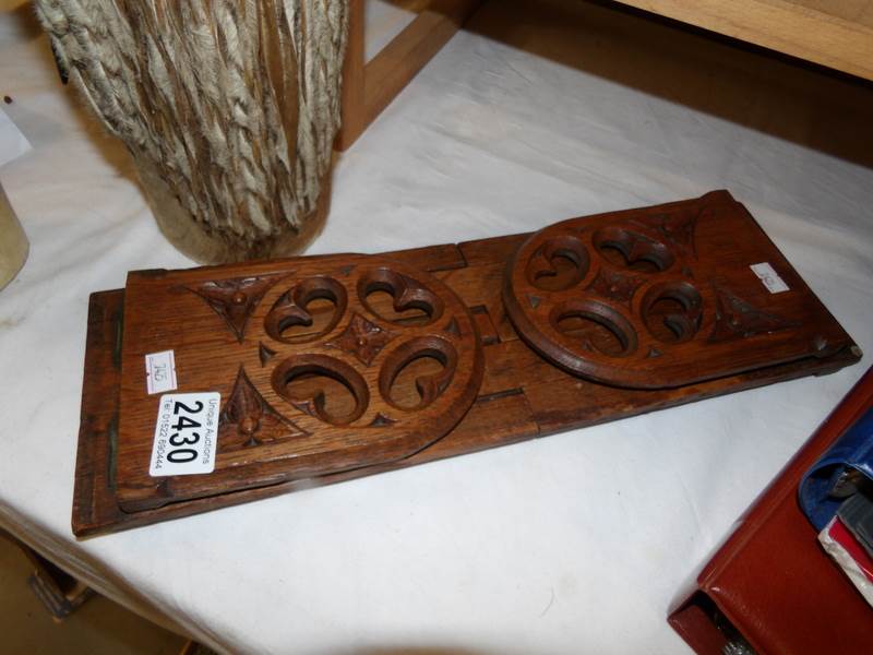 An oak extending book rack.