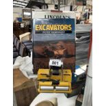 A model of Bomag roller and 2 books on excavators