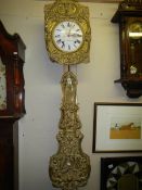 A French brass wall clock with pendulum.