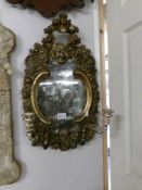 An antique gilt framed mirror, some a/f gilding and discoloured mirror), approximately 60 x 36 cm.