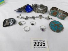 A mixed lot of silver and white metal jewellery including rings and bangles featuring designs from