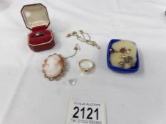 A silver ring, a rolled gold cameo and other costume jewellery.