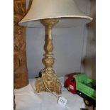 A carved table lamp with shade.