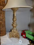 A carved table lamp with shade.