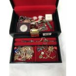 A black leather jewellery box with contents mainly vintage costume jewellery