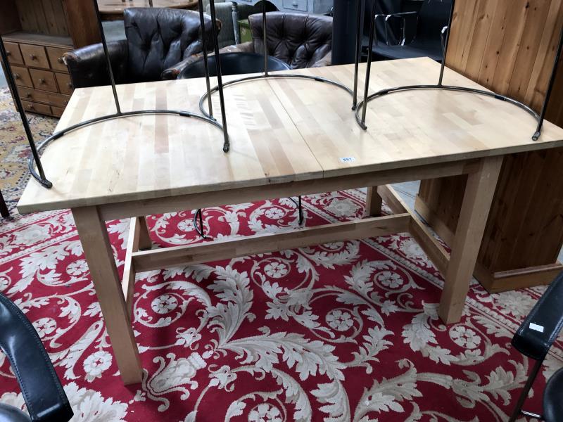 A pine extending dining table with chopping clock type top