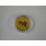 A 2014 24ct gold Canadian Maple Leaf coin with certificates.