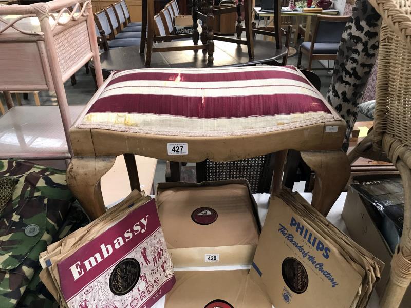 An Edwardian dressing table stool with Queen Anne legs on pad feet