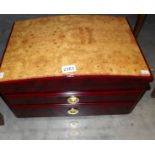 A modern jewellery chest with birds eye maple top.