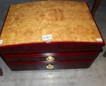 A modern jewellery chest with birds eye maple top.