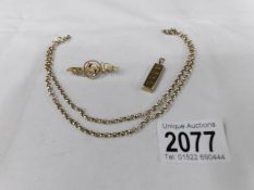 A 9ct gold neck chain, a 9ct gold brooch and a 9ct gold ingot, approximately 16 grams.