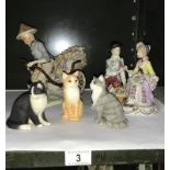 A collection of figurines and cat models including a man with Rickshaw & courting couple