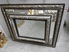 A 19th century French ebony mirror with gilt repousse' silver,, approximately 67 x 58 cm.