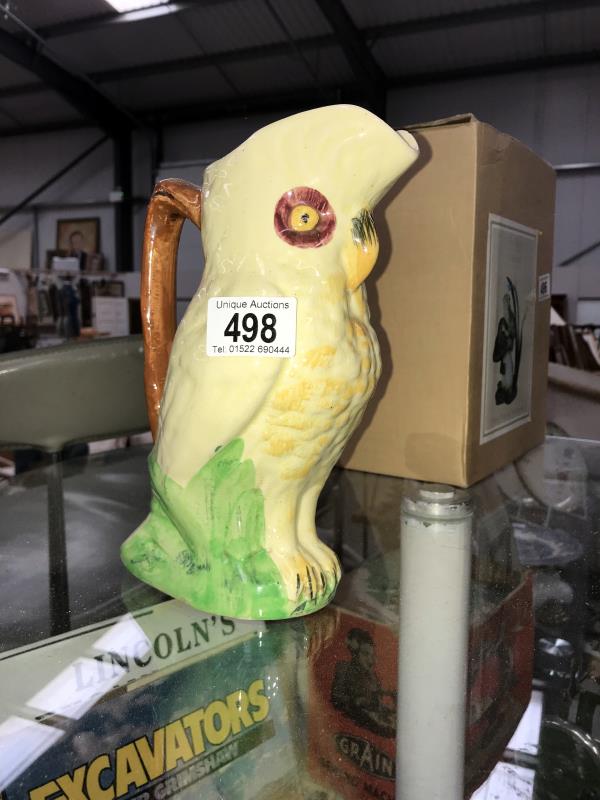 A 1920's pottery parrot water jug